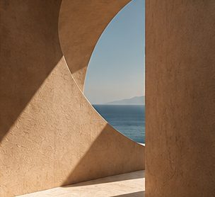 Curved stone wall opening to the sea