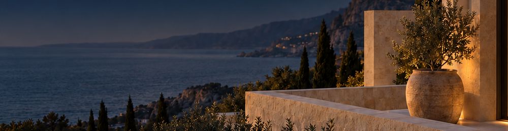 Stone terrace with an olive tree above the sea at dusk